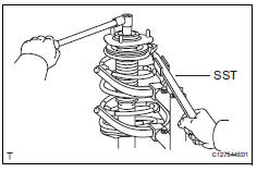 Toyota RAV4. Remove front support to front shock absorber nut